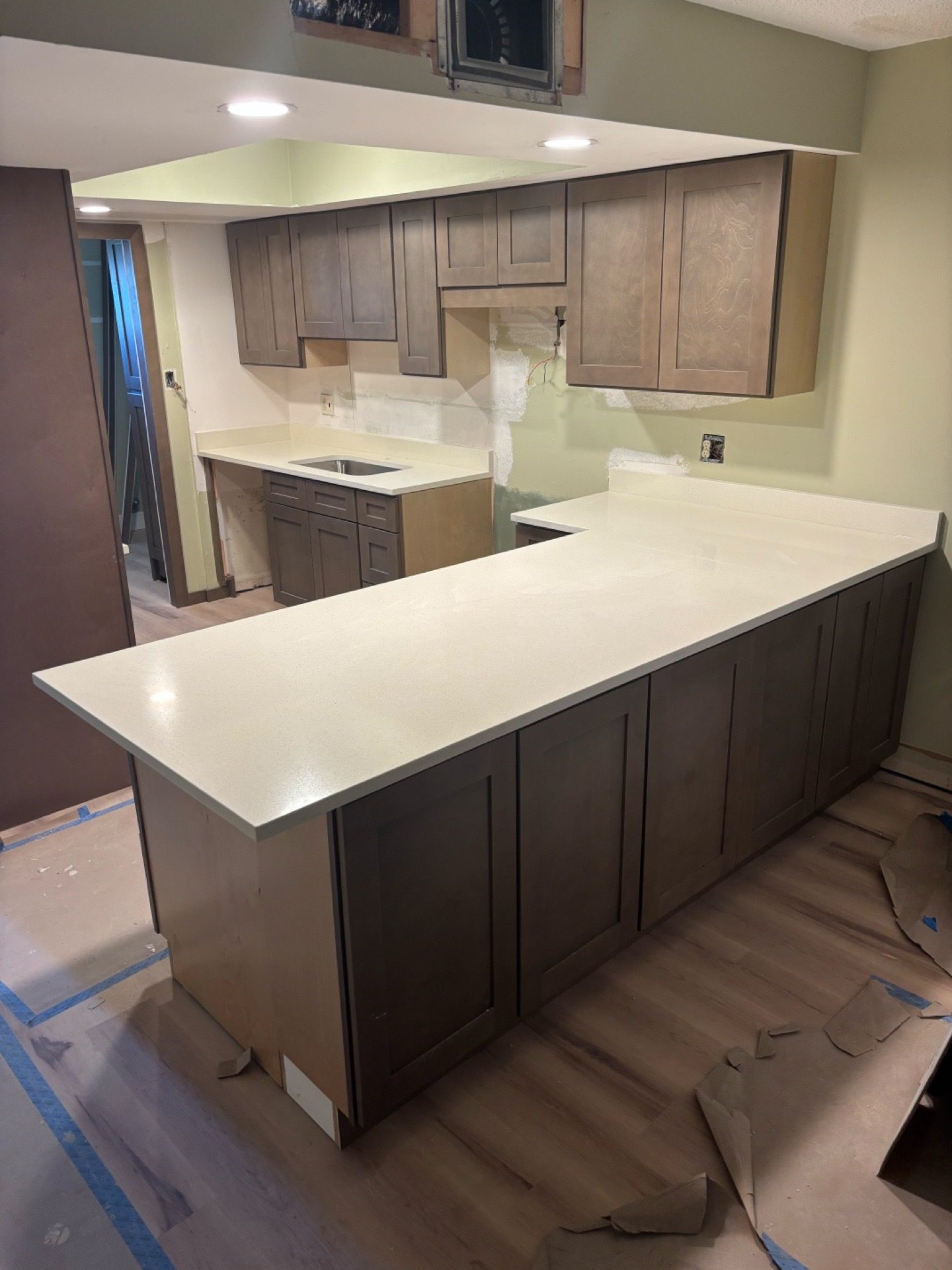 Kitchen remodel with clean white counters and wood cabinetry